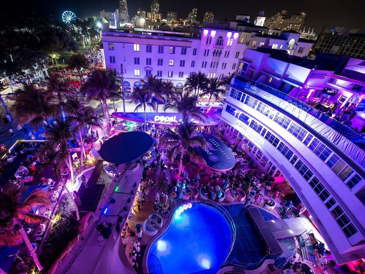 Clevelander pool party at night with purple lights
